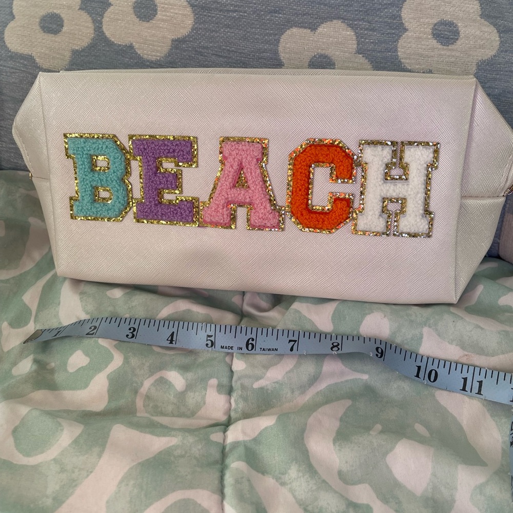 ‘NEW/ BEACH’ glitter bling cosmetic bag.